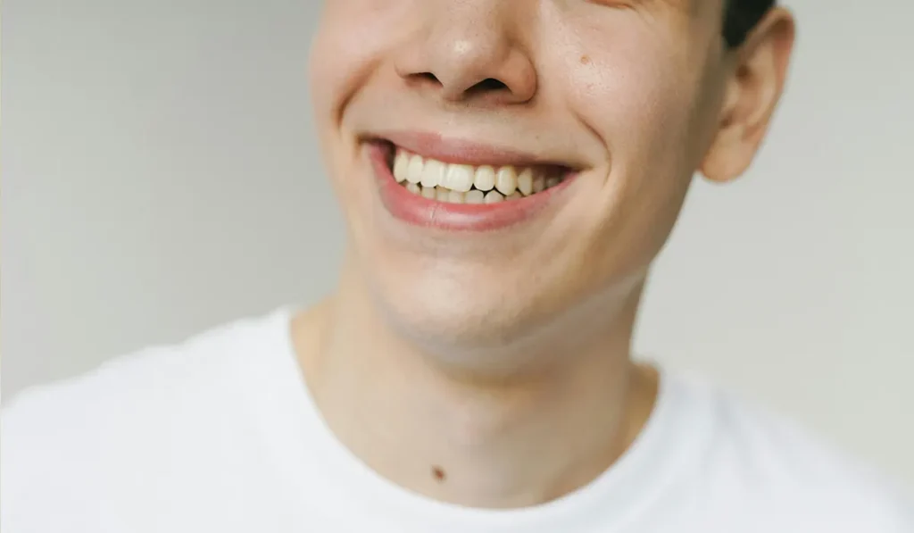 happy man smilliing showing his whitened teeth
